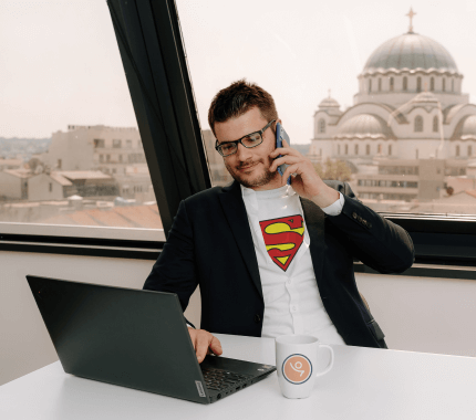 man in a superman shirt having a phone call